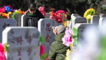 صينيون في مقبرة بمناسبة مهرجان تشينغ مينغ (فرانس برس)